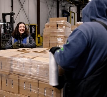 Brandi talking with someone in the warehouse