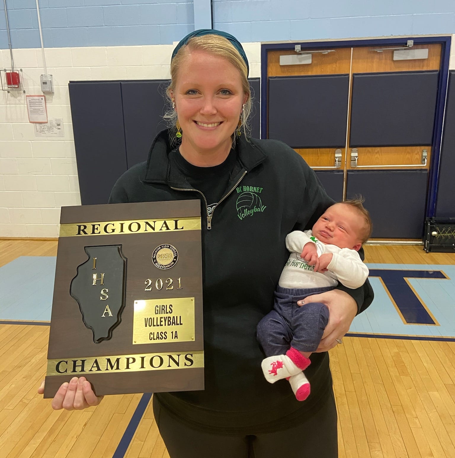 Katie holding regional volleyball plaque