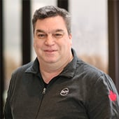 Dot Foods Canada's Director of National Sales James Baggs in front of windows at Dot Foods Mt. Sterling